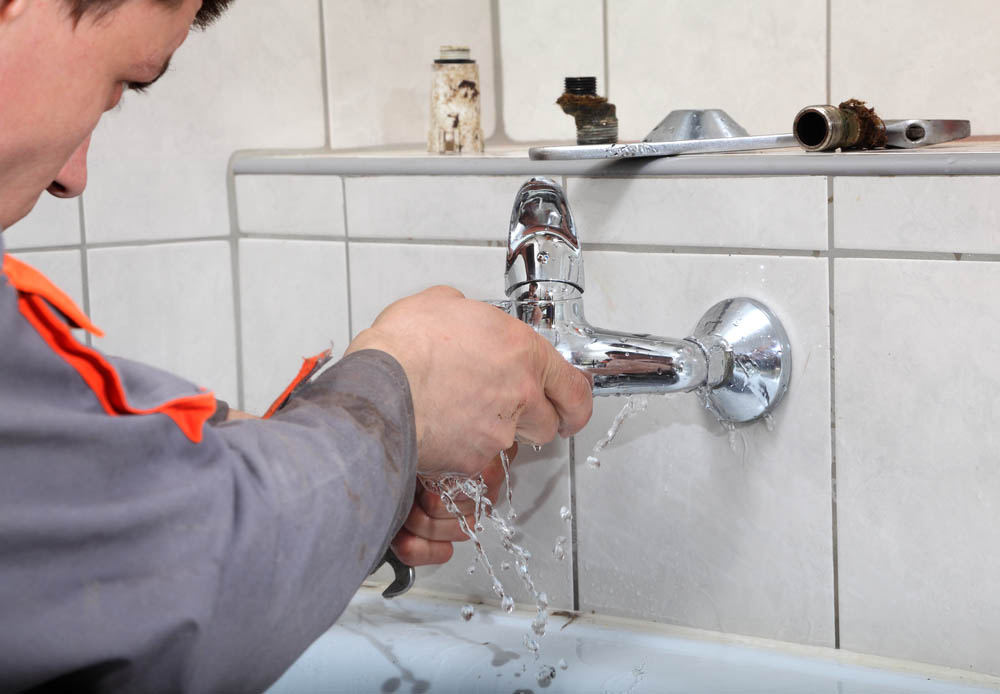 plumber fixing leaking tap Mesa, AZ