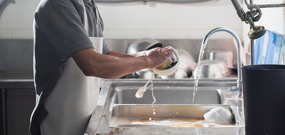 person washing dishes water softener Gilbert, AZ