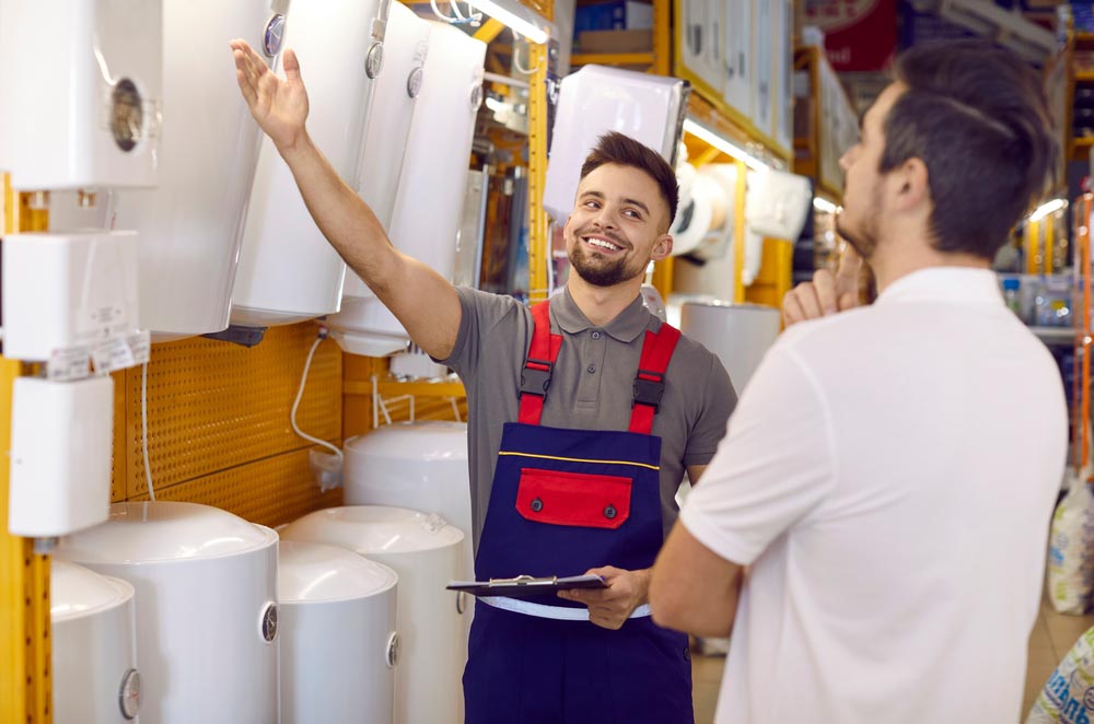 an electric and a gas water heater next to each other