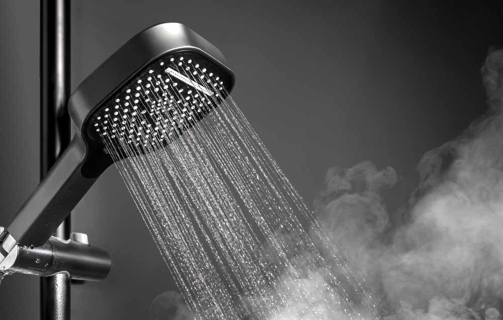 showerhead running hot water with light steam