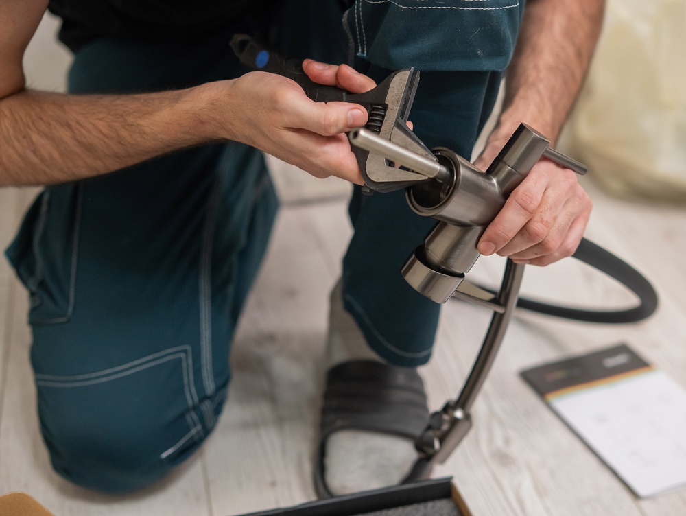 plumber installing a faucet