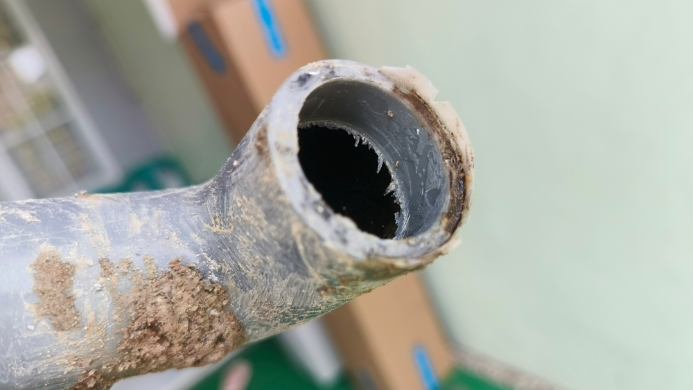 Closeup of old clogged water pipe.