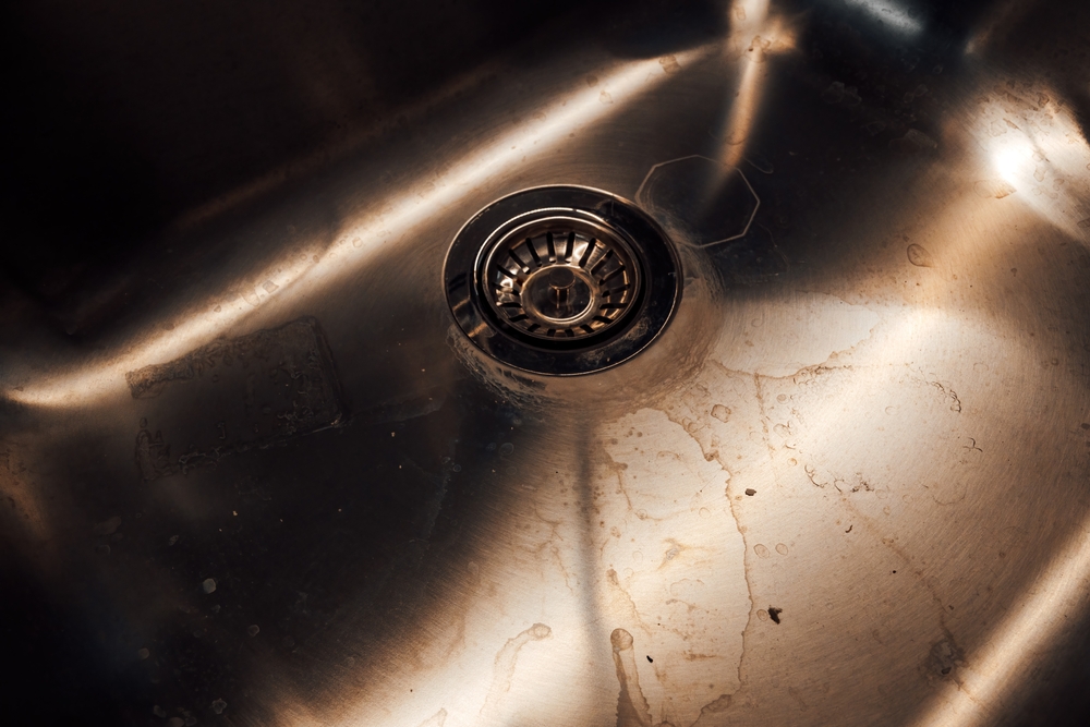Dirty stained metallic kitchen sink drain