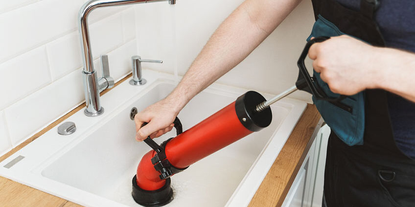 A Person Cleaning the Sink Drain