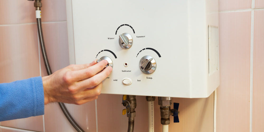 homeowner looking at their water heater/ water heater